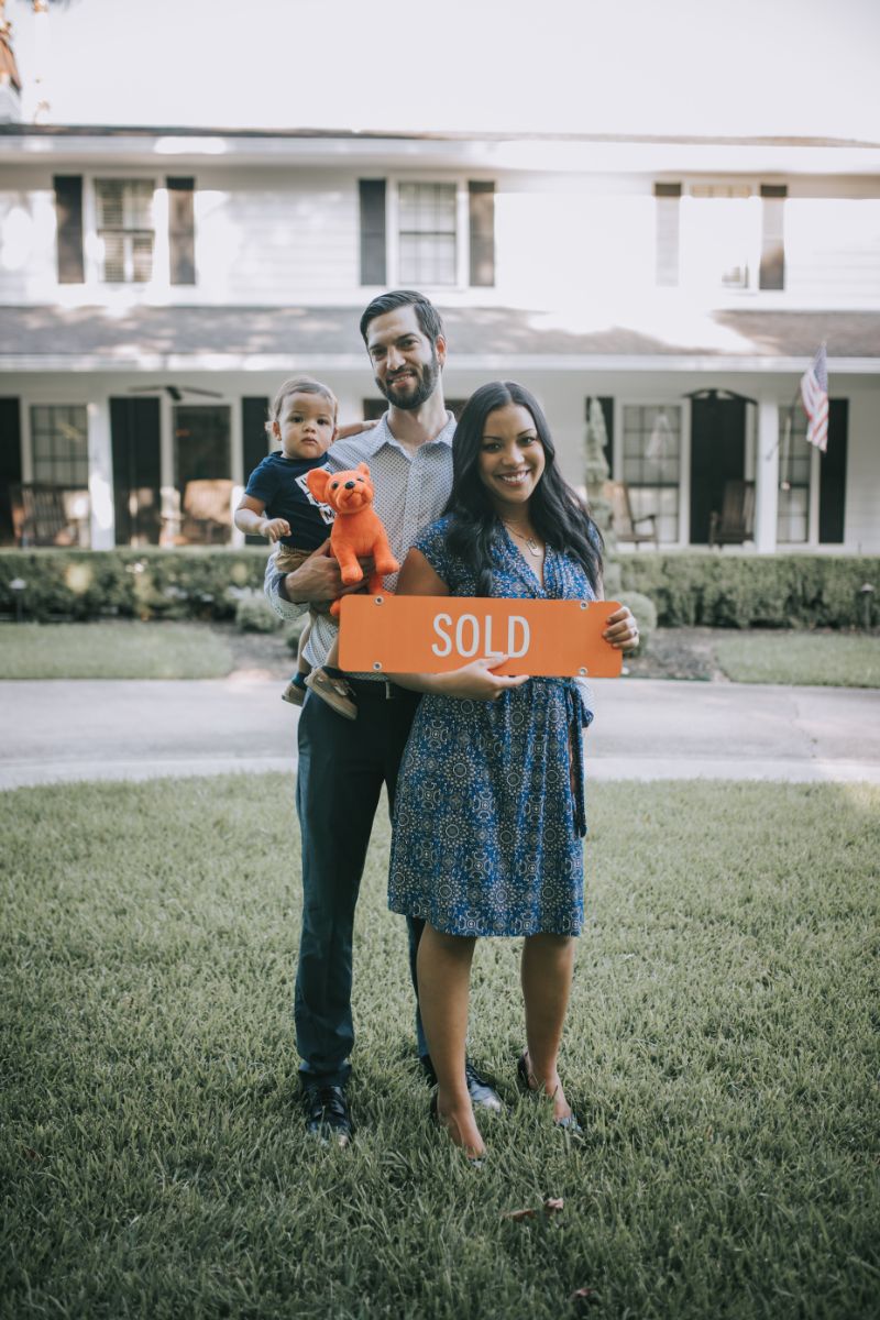 large living room with wood floors and steps to kitchen