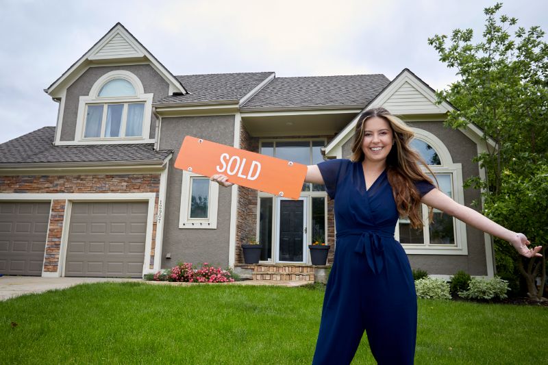 small living room with brick walls and shelves beside two chairs